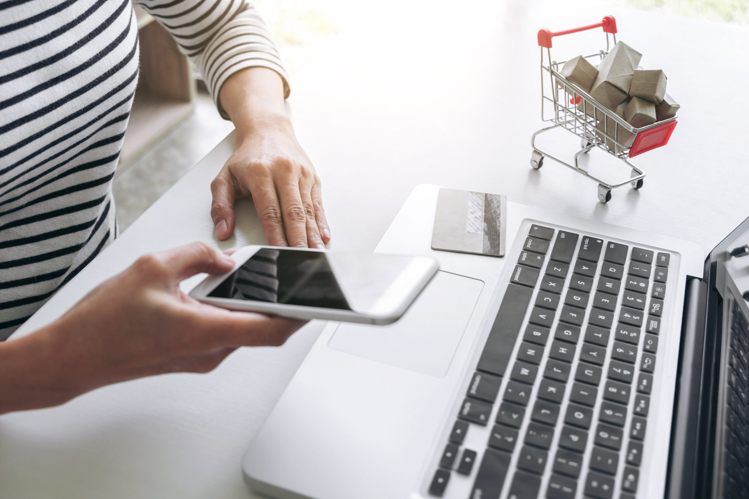 happy woman using smart phone credit card register payments online shopping custom scaled